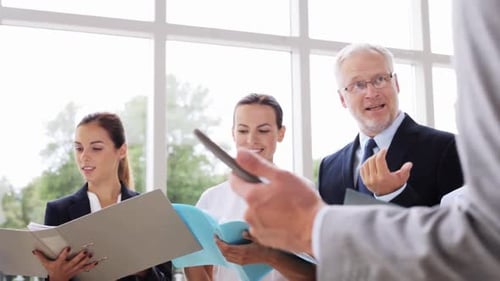 People, Work and Corporate Concept - Business Team with Folders and Tablet