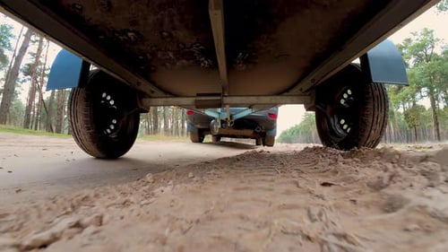 Freight Vehicle Driving By Sandy Road Cargo Delivering Truck with Dirty Tyres Rotation on Trailer