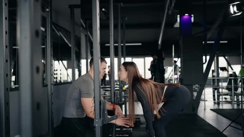 Woman Doing Deadlifts with Personal Trainer in Gym Fitness and Motivation
