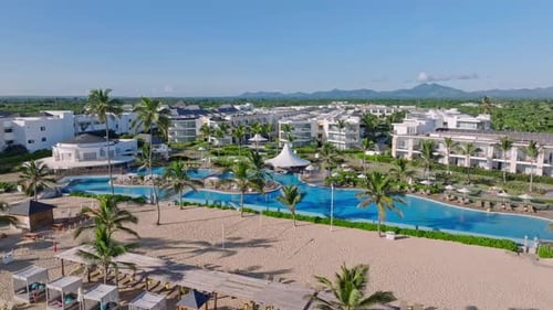 Tropical Beachfront Hotels With Swimming Pool On A Sunny Summer Day In Punta Cana, Dominican Republi
