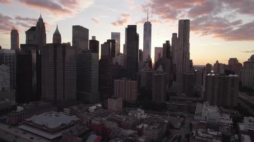 Aerial view towards backlit skyscrapers on the east side of lower Manhattan, sunset in NYC, USA