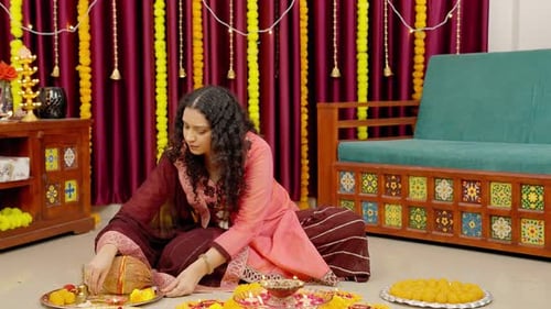 Woman Prepares Items for Hindu Celebration Indoors