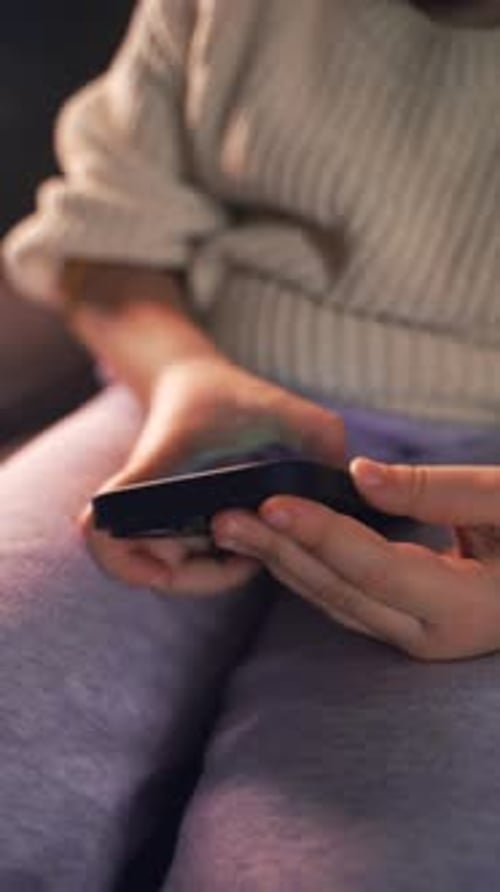 Child Using a Phone Indoors, Close Up