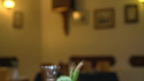 Hands of couple raising toast with glasses of red wine at the restaurant. Close up.
