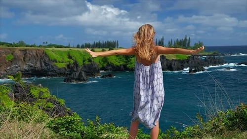 Woman Enjoying Ocean View on Cliffside