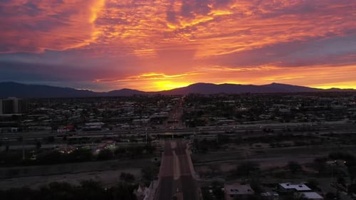 Dramatic Sunset Behind The Mountain Range From Phoenix City In Arizona, USA. - aerial ascend
