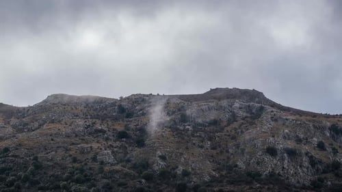 Clouds moving over a peak
