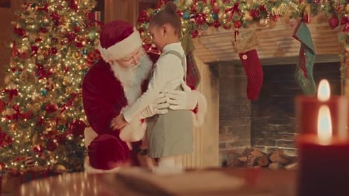 Festive Child Embraces Santa Claus at Christmas