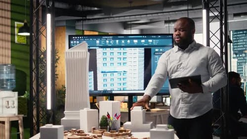 Property Investment Developer Checks Blueprints and Layout Plans