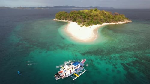 Tropical Island Paradise with Boat and Swimmers