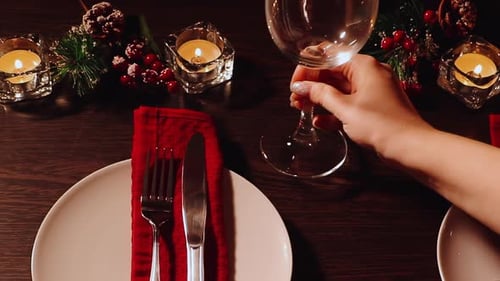 Holiday Table Setting with Wine Glass and Candles