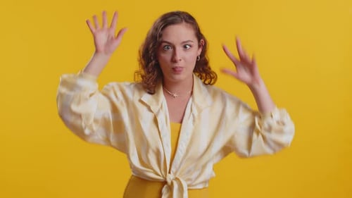 Young Woman Makes Funny Faces in Studio