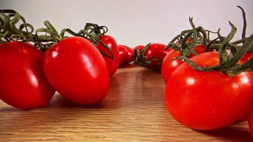 Moving Through Fresh Red Tomatoes on Table