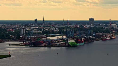 Aerial view of Riga port with city skyline and docked cargo ships
