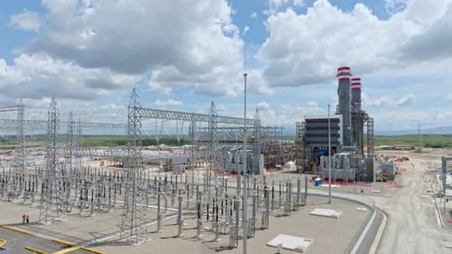 Aerial view of power plant and high-voltage electrical substation. Drone ascending