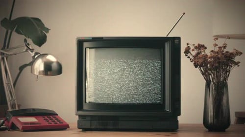 Old television with static display on a desk