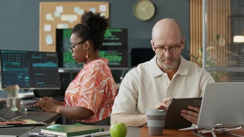 Diverse Software Engineers Developing Program Code in Open Space Office