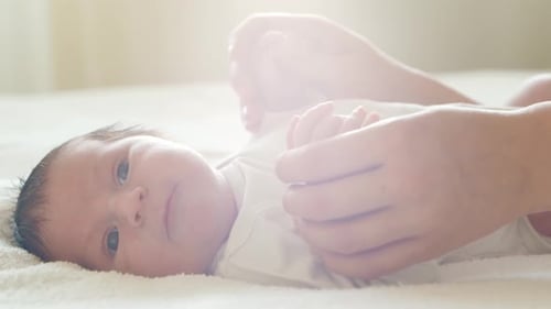 Newborn Baby Relaxing in Bright, Soft Light