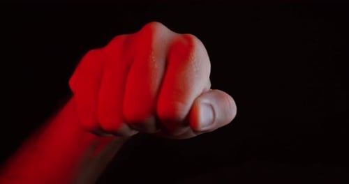 Fist Punching in Dark Red Lighting Close Up