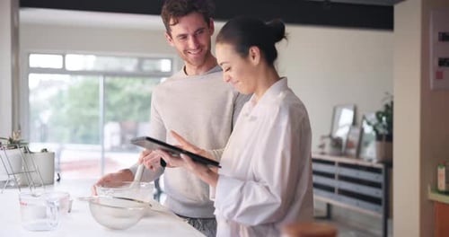 Happy Couple Prepares Food Together at Home