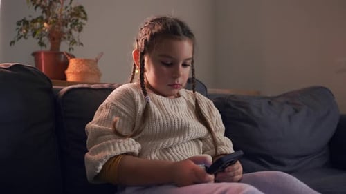 Girl on Couch Using Smartphone in Living Room