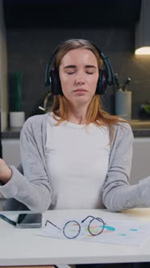 Attractive Woman Doing Meditation at Home Sitting on Tabte Relieves Stress By Practicing Yoga and