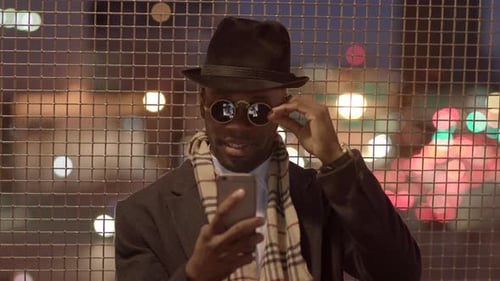 Fashionable Cool Male Artist Wearing a Hat and Sunglasses in the City Streets