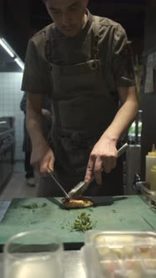 Young Adult Chef Dicing Food in Kitchen
