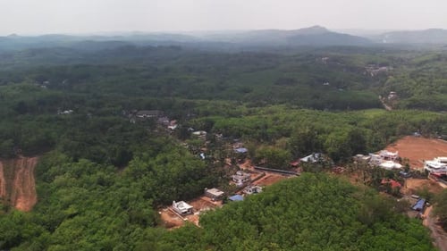 A rural area in south India which is surrounded by hills. Deforestation by houses.