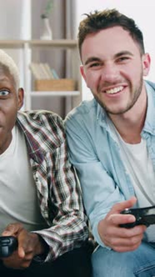 Two Young Men Playing Video Games at Home