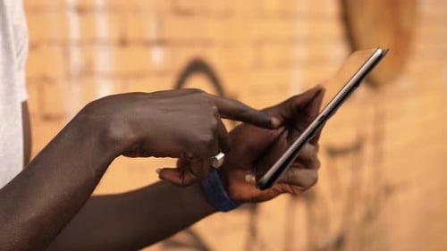Adult Using Tablet in Urban Setting