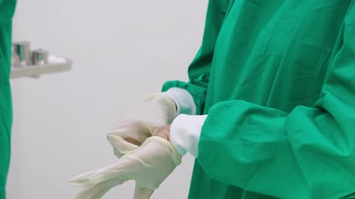 Surgeon Putting on Surgical Gloves in Hospital Setting