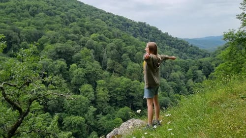 Happy Hiker feiert das Erreichen des Gipfels mit erhobenen Armen im Triumph inmitten atemberaubender Natur