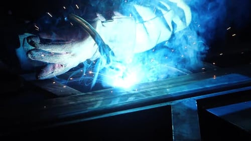 Repair in Workshop. Glowing Stream of Metal Weld Spark Particles Shine In