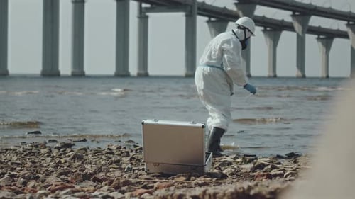Scientist in Hazmat Suit Testing Water Quality