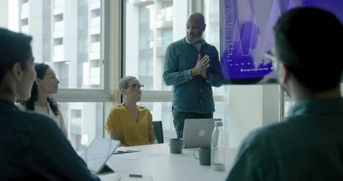 Businessman Presenting, using Graph on Screen during Meeting in Office Meeting room