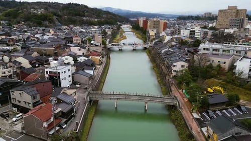 Aerial view following the river through the city of Kanazawa, fall day in Japan