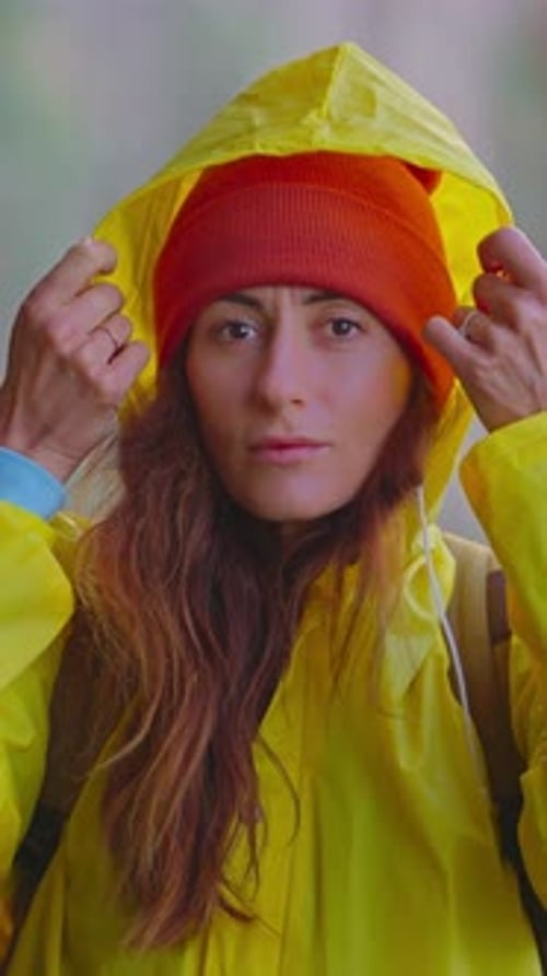 Smiling Woman Wearing Rain Jacket and Beanie