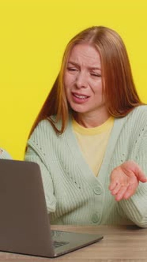 Woman with Headache at Laptop Computer in Studio