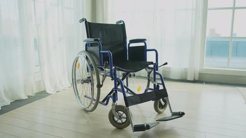Empty Wheelchair Waiting for Patient Services in Living Room Retirement Home Hospital Chair for