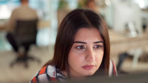Smiling Woman Working at the Computer in Office