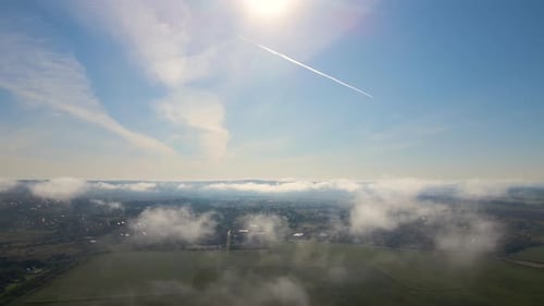 Aerial View From High Altitude of Landscape Covered with Puffy Morning Fog