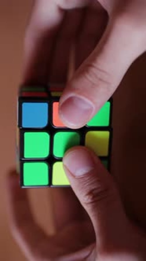 Rubik's Cube in the Hands of a Man Close Up Vertical Video