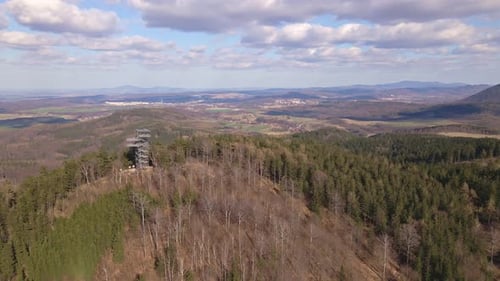 Drone Flight Over Mountains Covered with Forest and Observation Tower on Peak