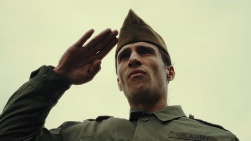 Serious Soldier Salutes Outdoors in Daylight