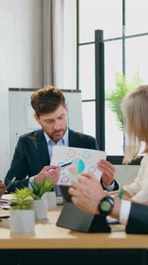 Business People in Meeting Reviewing Charts