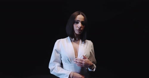 Woman Posing in Studio with Dark Background