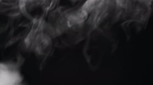 Wispy White Smoke Filling Black Background