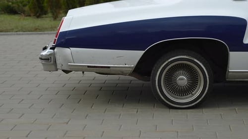Vintage Two-Toned Car on Brick Sidewalk