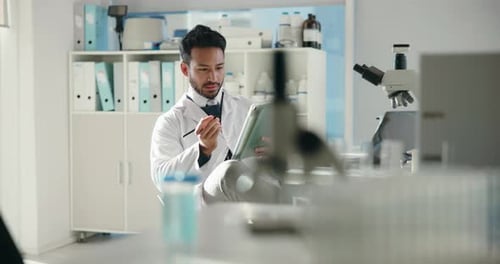 Scientist Working with Tablet in Modern Lab